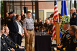 Family members stand before memorial wreath