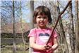 Little girls holds a branch