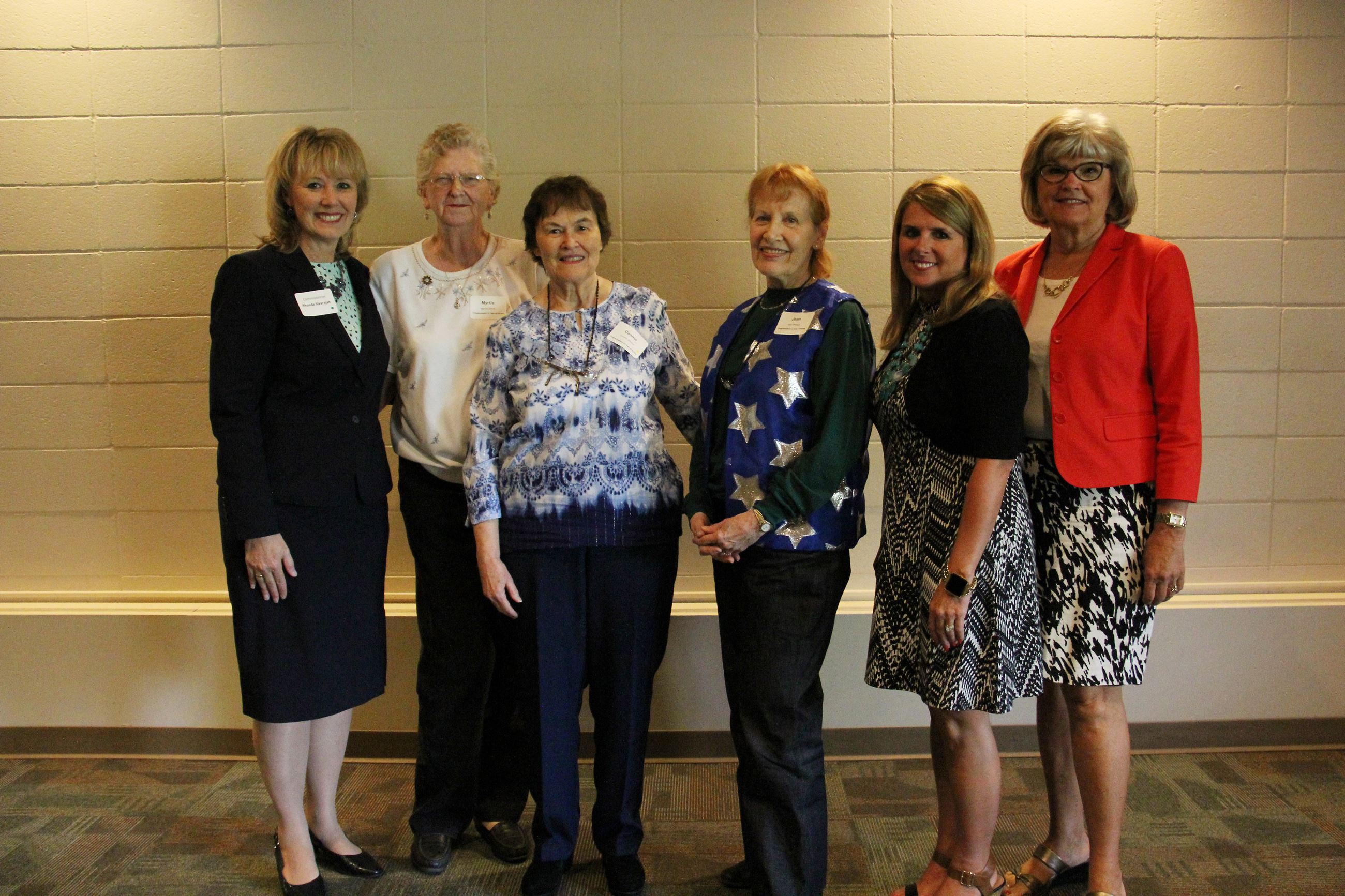 Commissioners stand with RSVP events guests