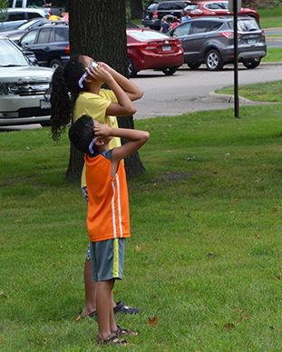 Children trying their new eclipse glasses.