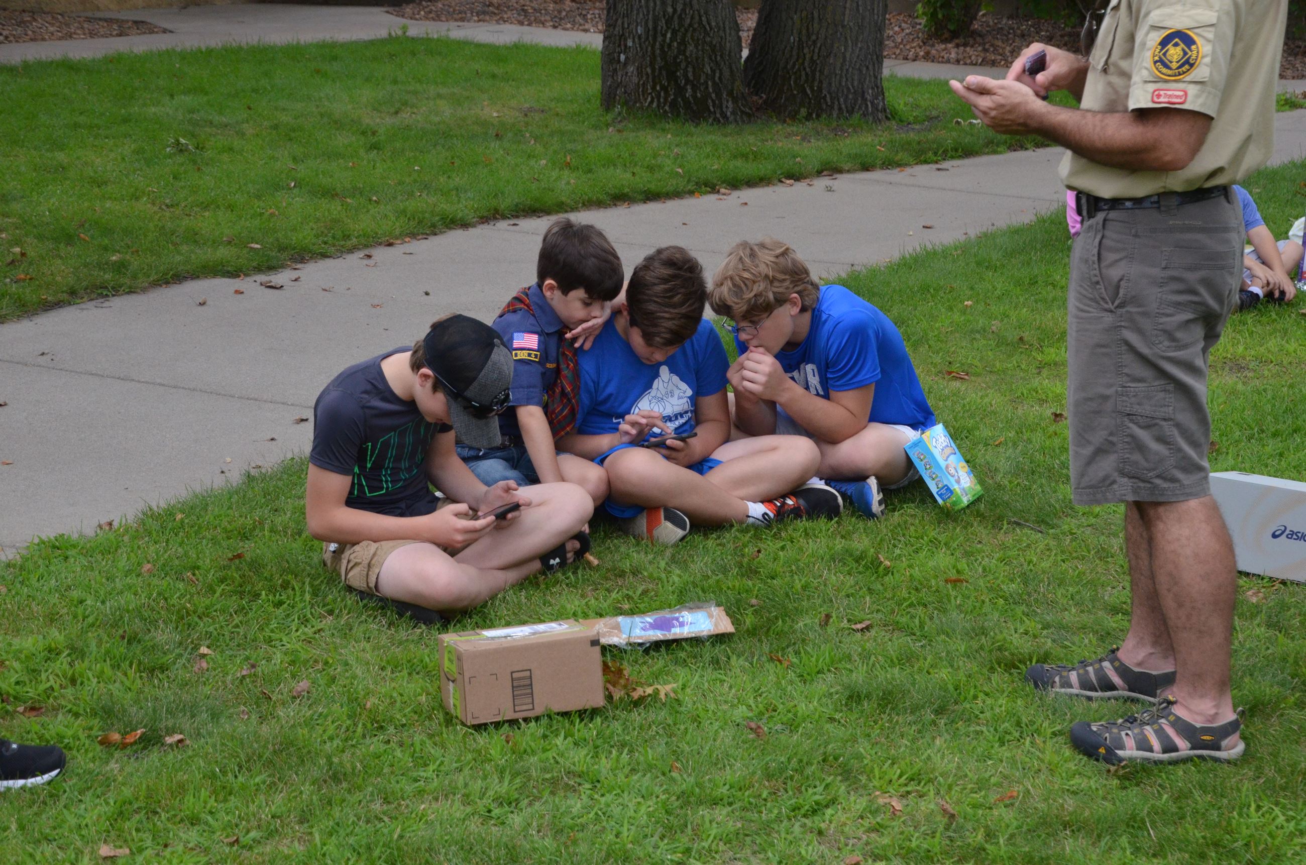 Event goers watch the live stream of the full eclipse while they wait