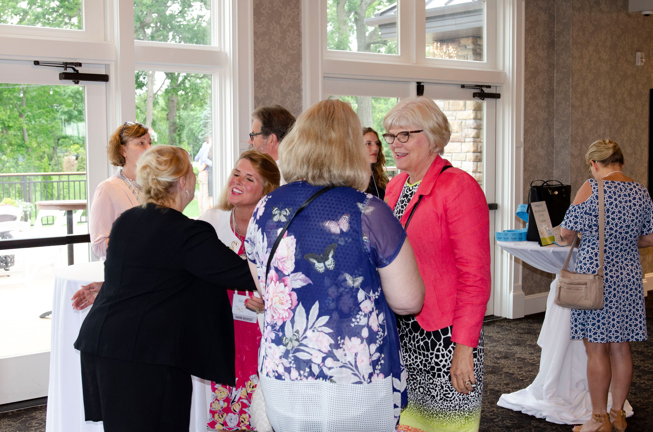 Commissioners Braastad and West speak with Lisa Jacobsen, President & CEO of HOPE 4 Youth, and event