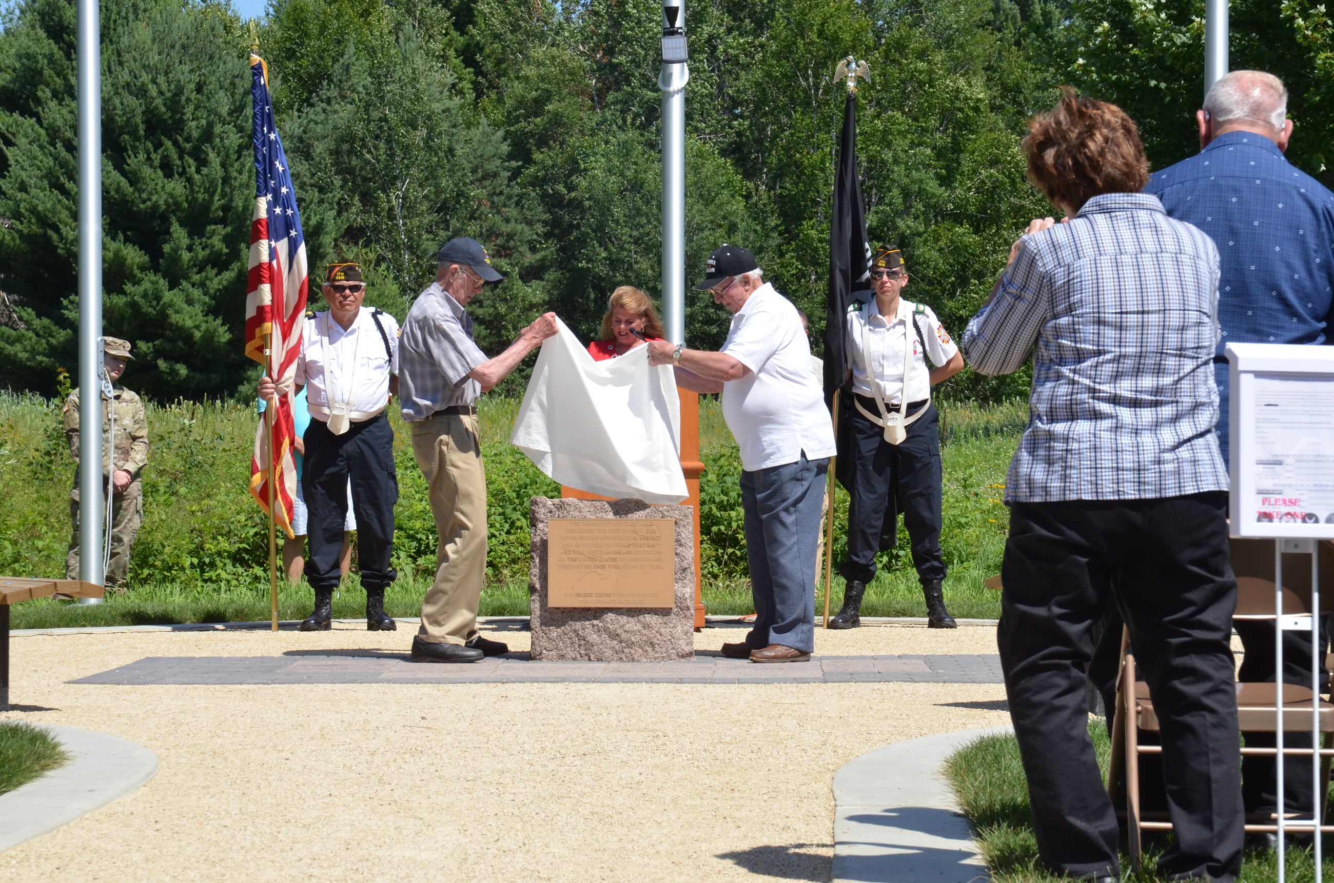 Ken Langmade and Clarence Anderson uncover the monument plaque