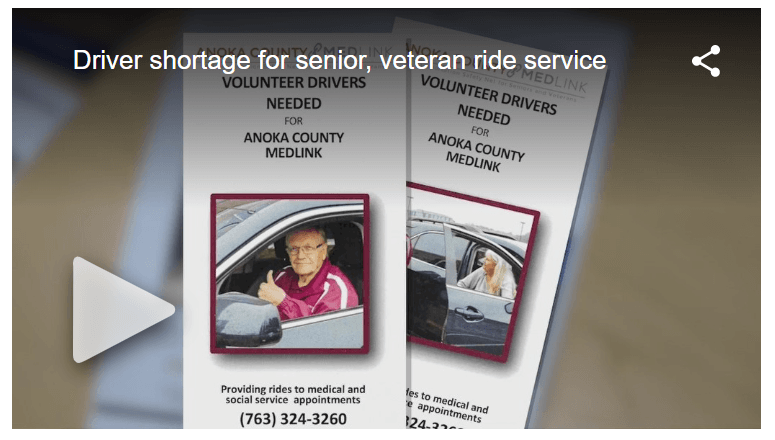 Picture of male driving car giving thumbs up while volunteering