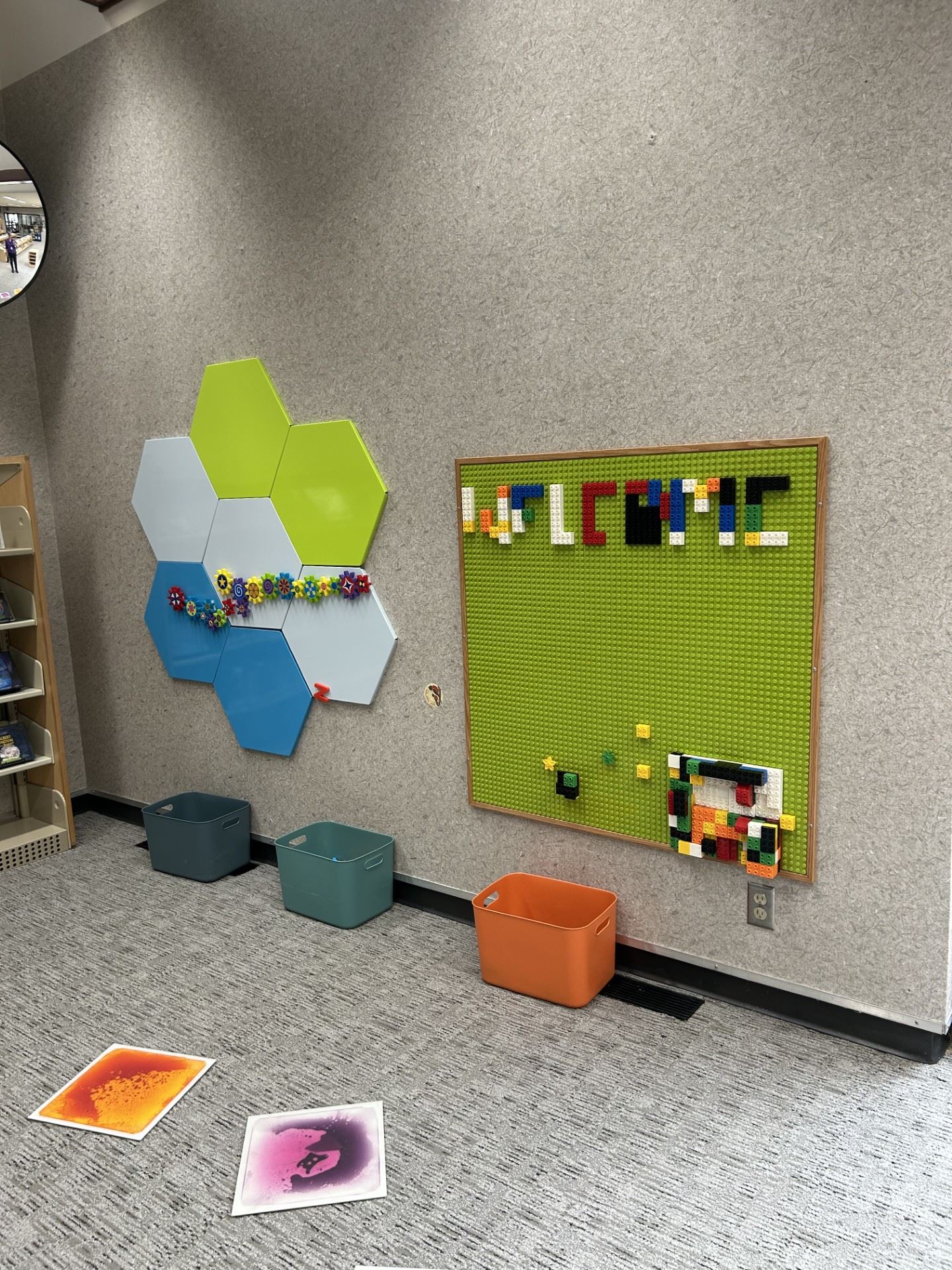 Colorful hexagon magnetic wall tiles with toys attached, and a toy brick wall